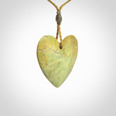 A hand carved heart pendant made from New Zealand Flower jade.